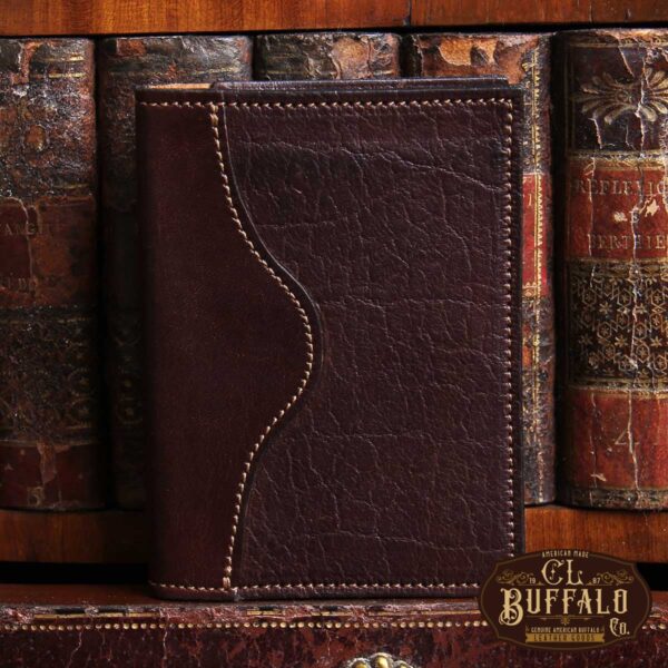 American buffalo tobacco brown no7 card wallet in front of vintage books with CL Buffalo logo in bottom right hand corner