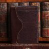 american buffalo tobacco brown no7 card wallet in front of vintage books