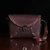 buffalo leather crossbody box bag on table - front view
