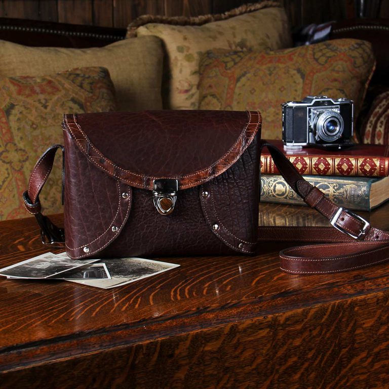 buffalo leather crossbody box bag on table