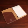 Leather travel portfolio in tabacco brown american buffalo on a wood table - open view