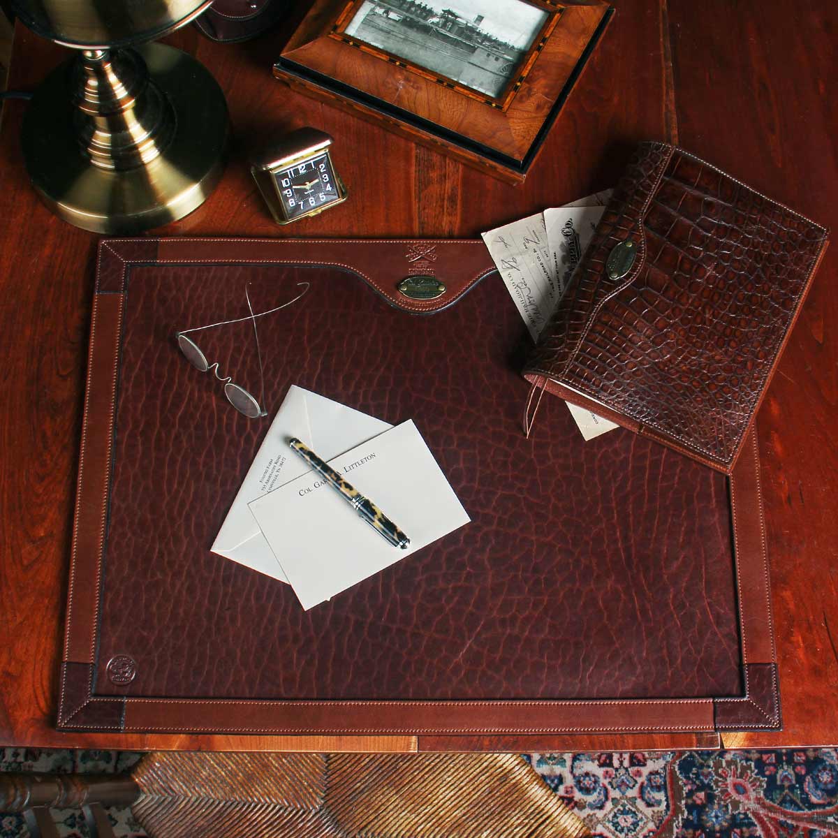 no17 tobacco brown american buffalo desk pad on desk with contents
