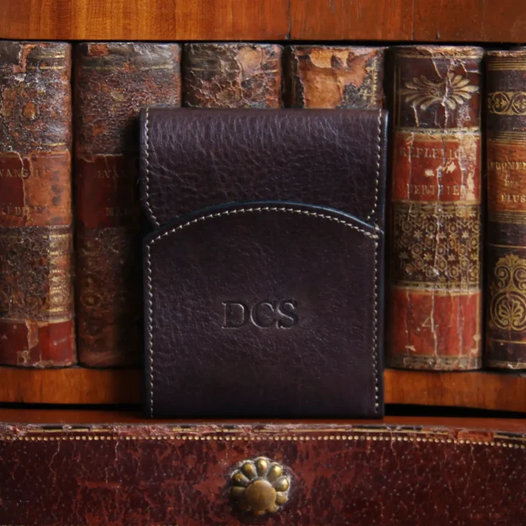 Dark brown american buffalo leather Front Pocket Wallet with fold-over flap - Front view on shelf in front of antique books