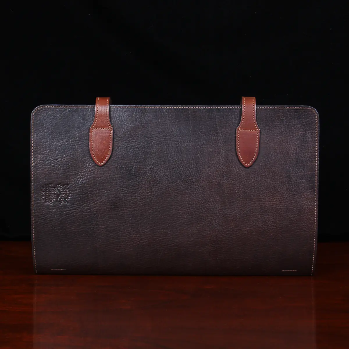 no 28 legal size leather portfolio in tobacco buffalo on a wood table - back view