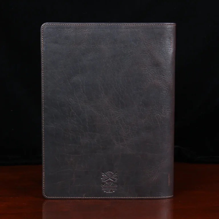 no 28 leather portfolio in tobacco buffalo - back view - on wood table with dark background