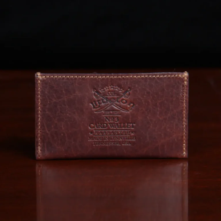 no3 card wallet in tobacco brown american buffalo - back view on wood table with dark background