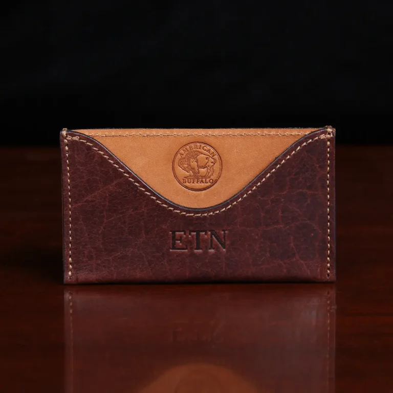 no3 card wallet in tobacco brown american buffalo - front view on wood table with dark background