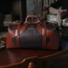 No. 5 Grip in Tobacco Brown American Buffalo with Vintage Brown Steerhide trim - front view of bag resting on antique coffee table in front of stone fireplace
