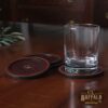 Tobacco Brown American Buffalo Leather Coasters on table with glass