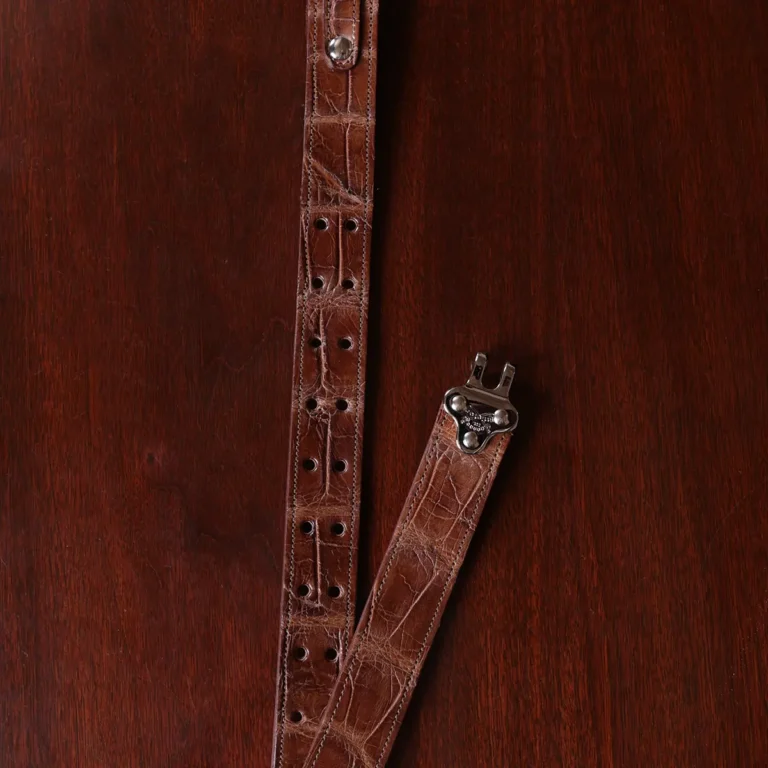 No. 5 Cinch Belt in Vintage Brown American Alligator with Nickle hardware - hook view a black background
