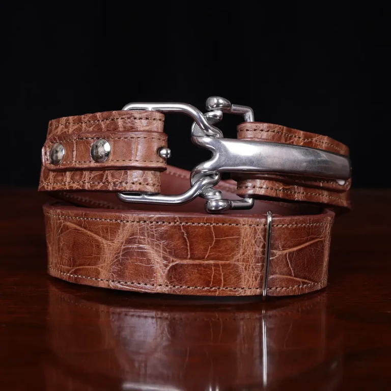 No. 5 Cinch Belt in Vintage Brown American Alligator with Nickle hardware - front view a black background