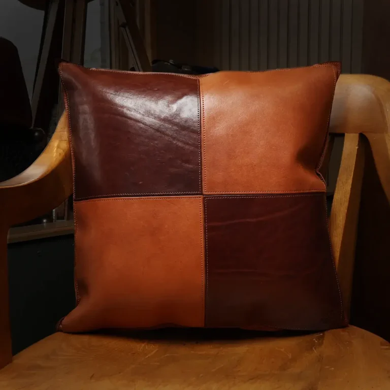 front of two tone leather pillow sitting in wood chair