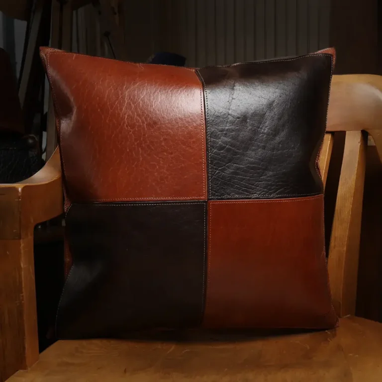 front of two tone leather pillow sitting in wood chair