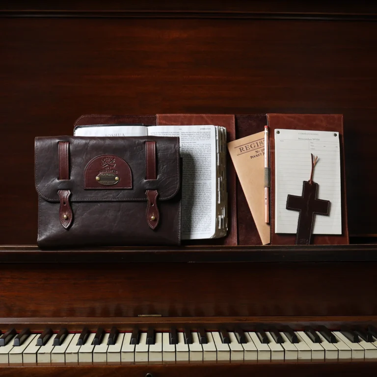Bible cover in front of a piano with it open with the journals and bookmark