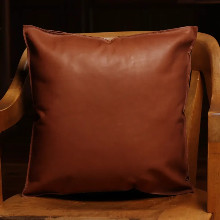 back of two tone leather pillow sitting in wood chair