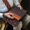 Colonel sitting holding the Tobacco Brown American Buffalo leather bible cover pulling a bible out