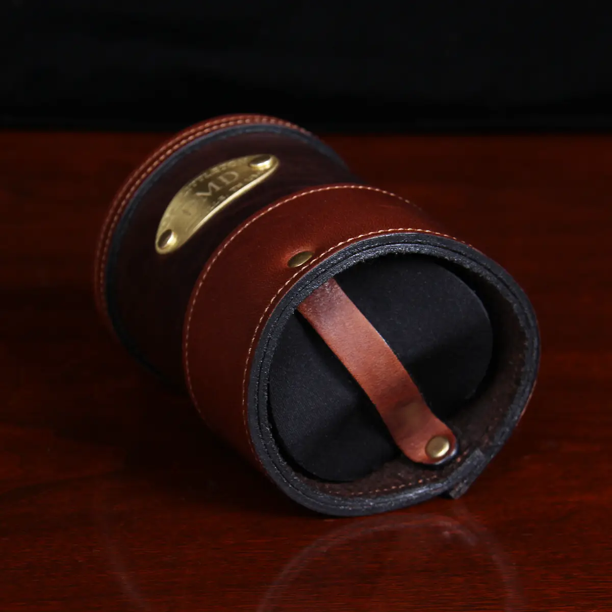 bottom of dark brown leather can coozie with plate