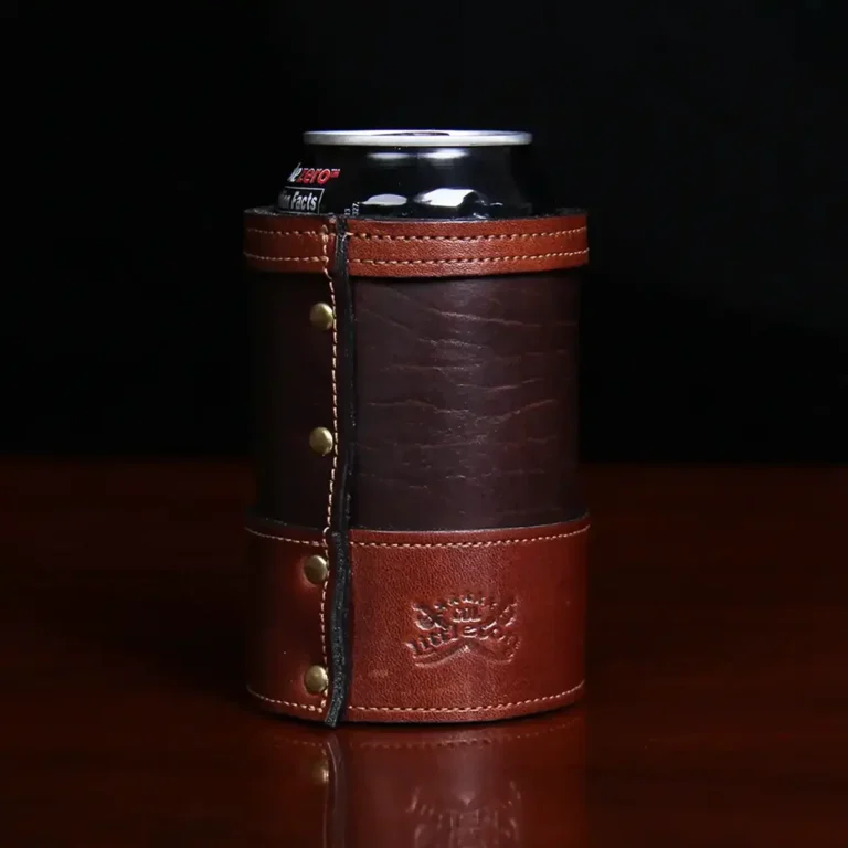 dark brown leather can coozie with soda can in it with plate