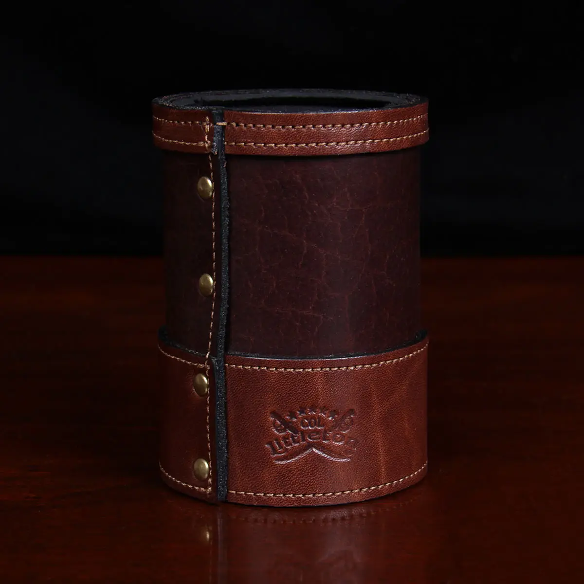 back of dark brown leather can coozie with soda can in it