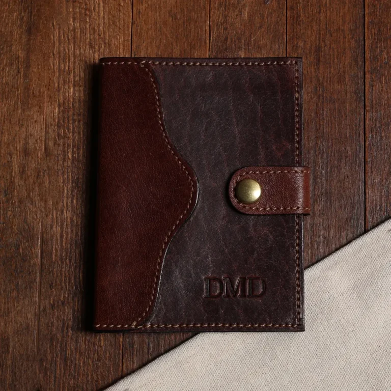 no 7 dark brown leather wallet with snap closure - front view on wood surface - tobacco buffalo