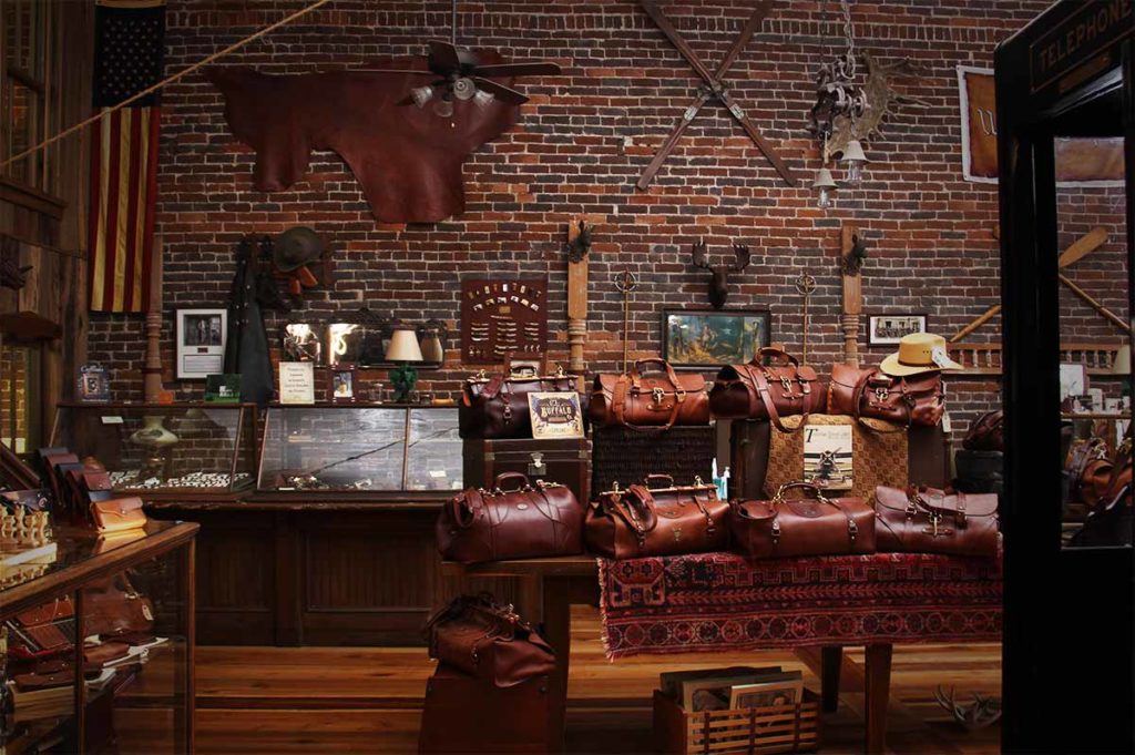 Inside of the Col. Littleton Retail Store, showing a collection of leather bags