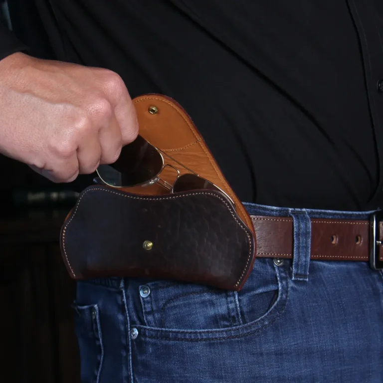 dark brown leather aviator sunglasses case showing man taking glasses out