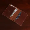 inside view of brown leather wallet with money and cards in pockets