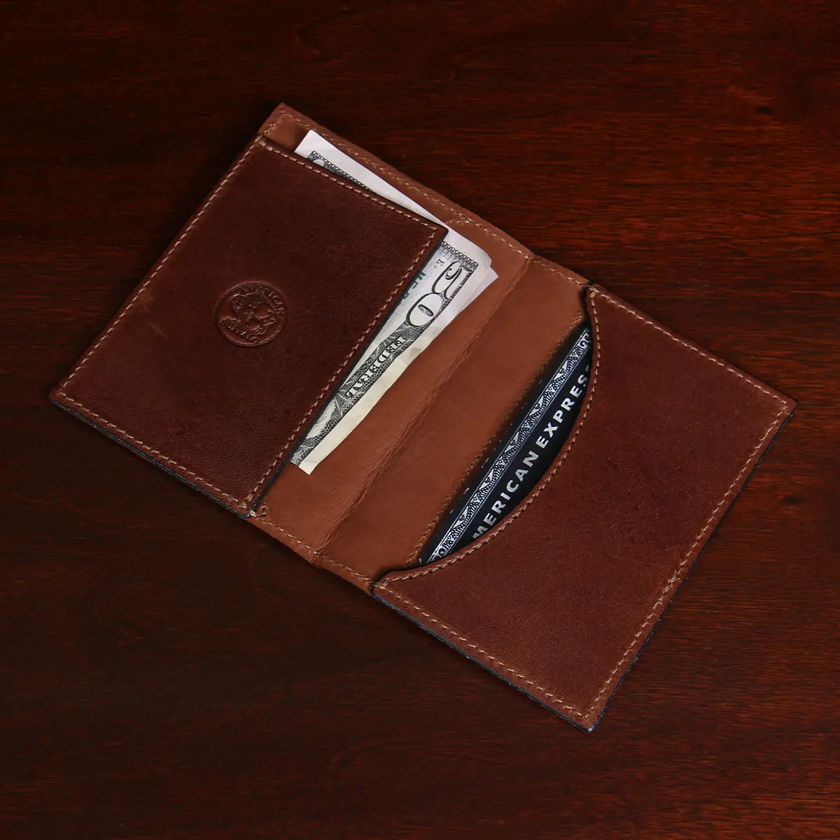 inside view of brown leather wallet with money and cards in pockets