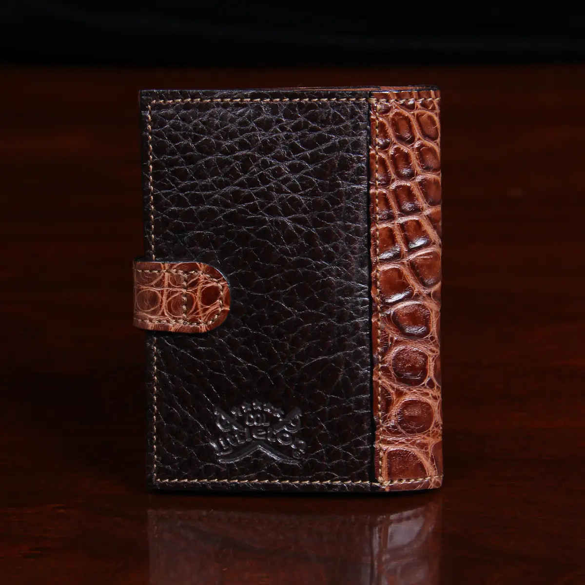 back view of dark brown leather wallet with snap closure and alligator trim