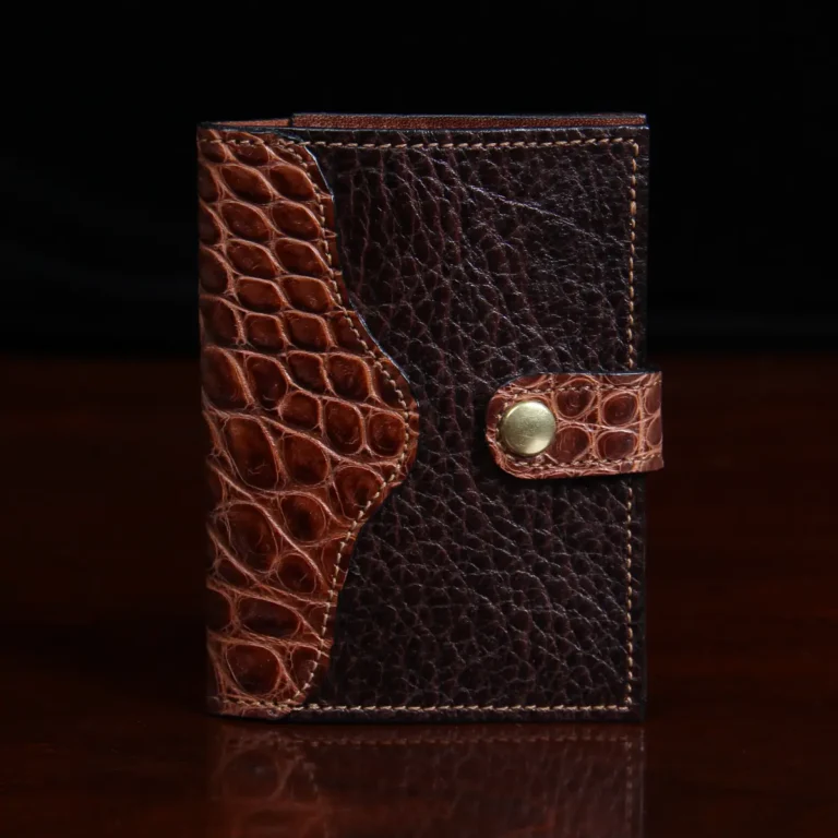 dark brown leather wallet with snap closure and alligator trim