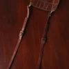 Bella Bag Ladies' Crossbody Purse in Tobacco Brown American Buffalo with Vintage Brown Steerhide Strap and American Alligator front panel - strap view on wood table