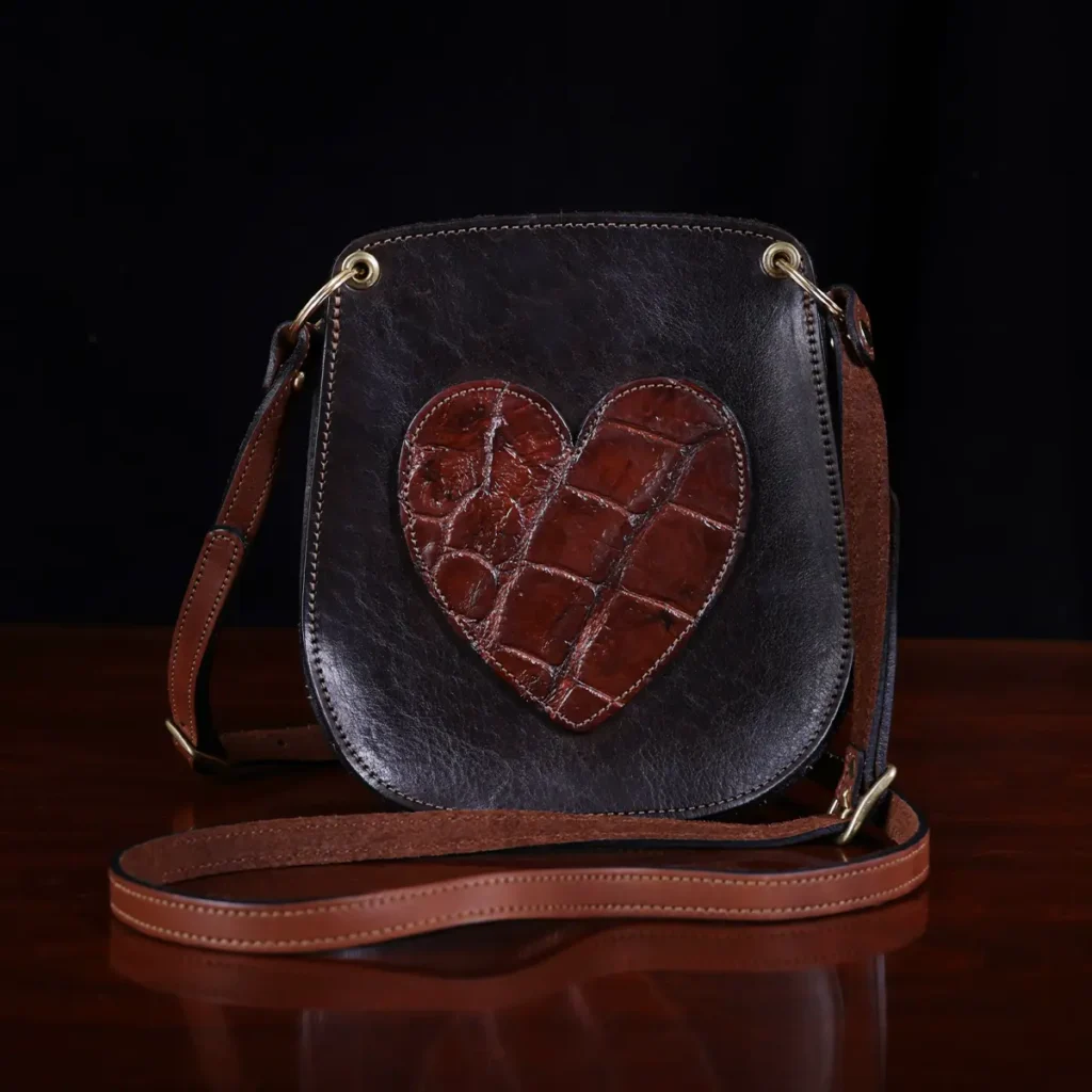 Bella Bag Ladies' Crossbody Purse in Tobacco Brown American Buffalo with Vintage Brown Steerhide Strap and American Alligator heart on front - ID 001 - front view on vintage black background