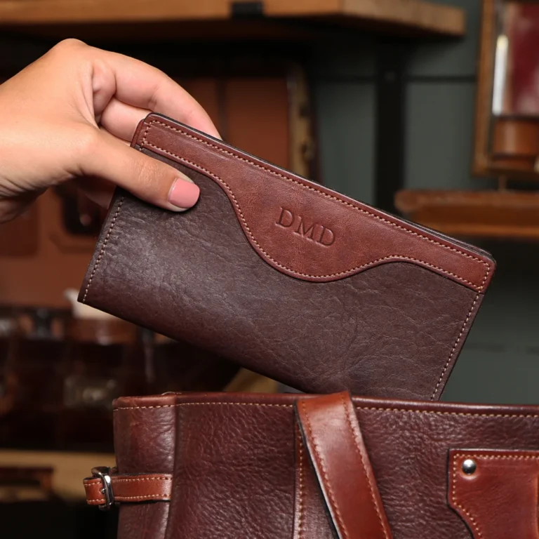 A hand holding a Tobacco Brown American Buffalo Checkbook