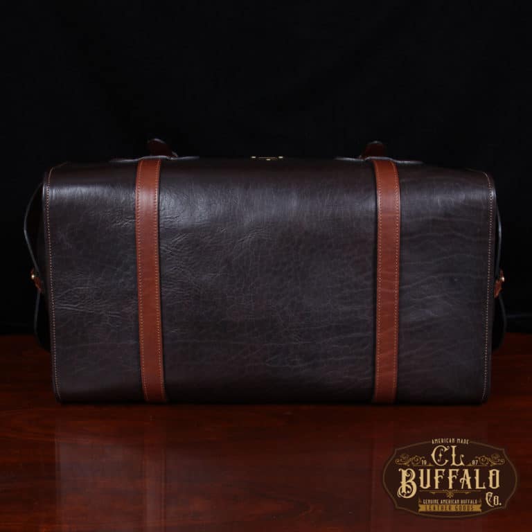 dark brown buffalo leather duffel bag on table - bottom view of bag