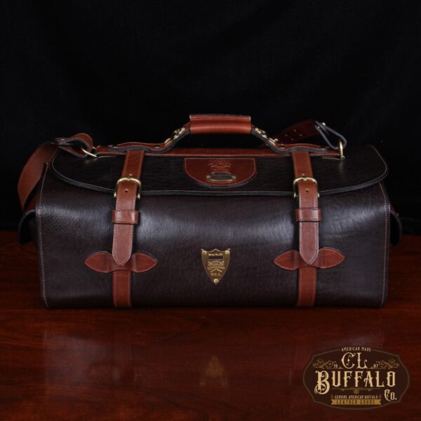 dark brown buffalo leather duffel bag on table - front view