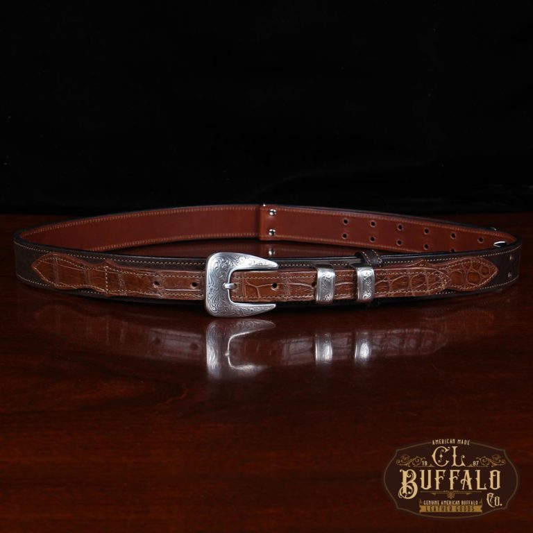 buffalo leather ranger belt with alligator trim sitting on wood table