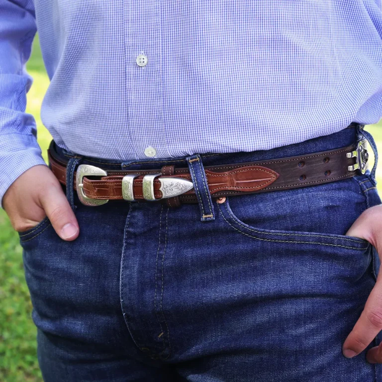 man wearing a buffalo leather ranger belt with alligator trim sitting on wood table