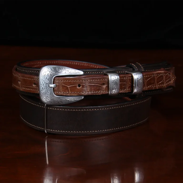 buffalo leather ranger belt with alligator trim sitting on wood table