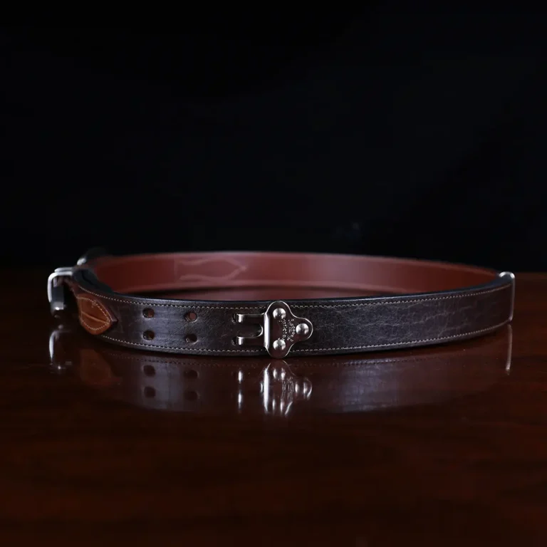 buffalo leather ranger belt with alligator trim sitting on wood table - side hook view