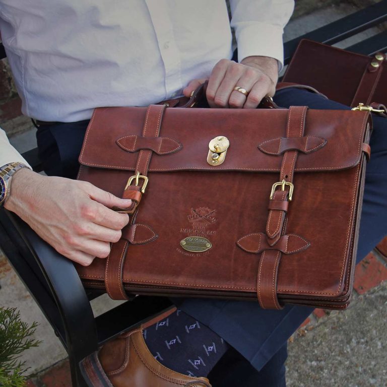 Man holding No. 1943 Navigator Briefcase in Vintage Brown Steerhide Leather
