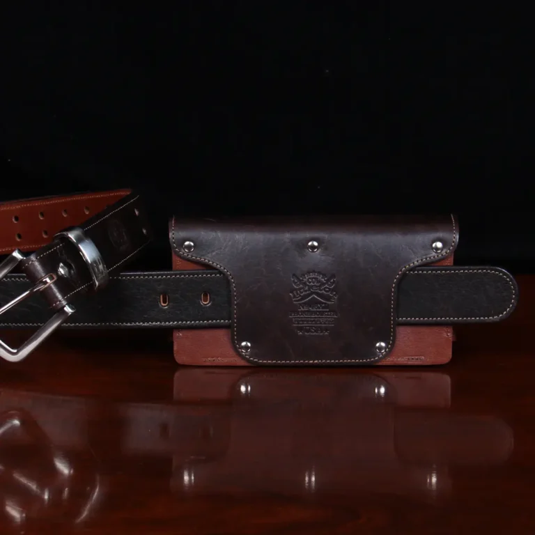 No. 48XL Phone Holster in Tobacco Brown sitting on a table with the belt looped through the back