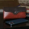 No. 48XL Phone Holster in Tobacco Brown sitting on a table with a phone in front