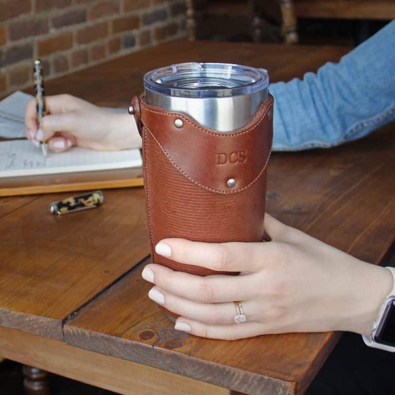 Woman holding No. 20 Tumbler set in Vintage Brown on table
