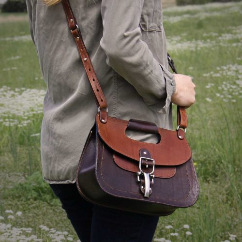 No. 17 Hunt Bag made of two-tone brown American Buffalo and Vintage Brown Steerhide leather worn crossbody on woman