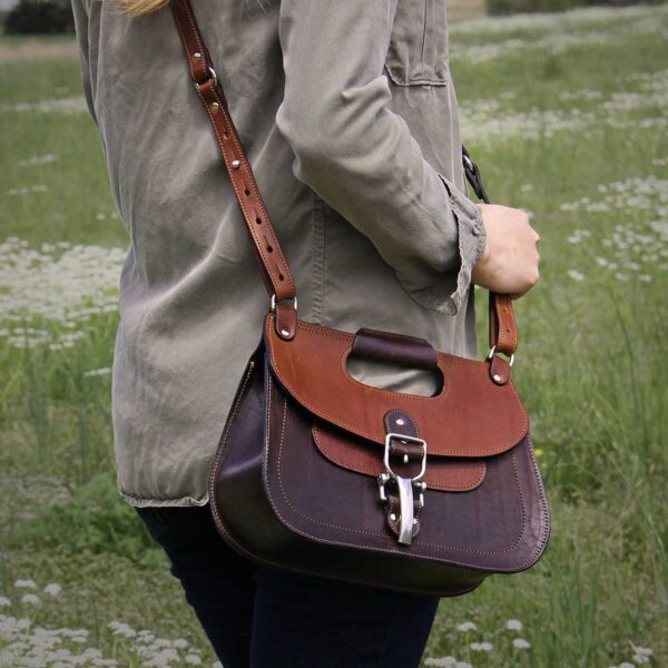 No. 17 Hunt Bag made of two-tone brown American Buffalo and Vintage Brown Steerhide leather worn crossbody on woman