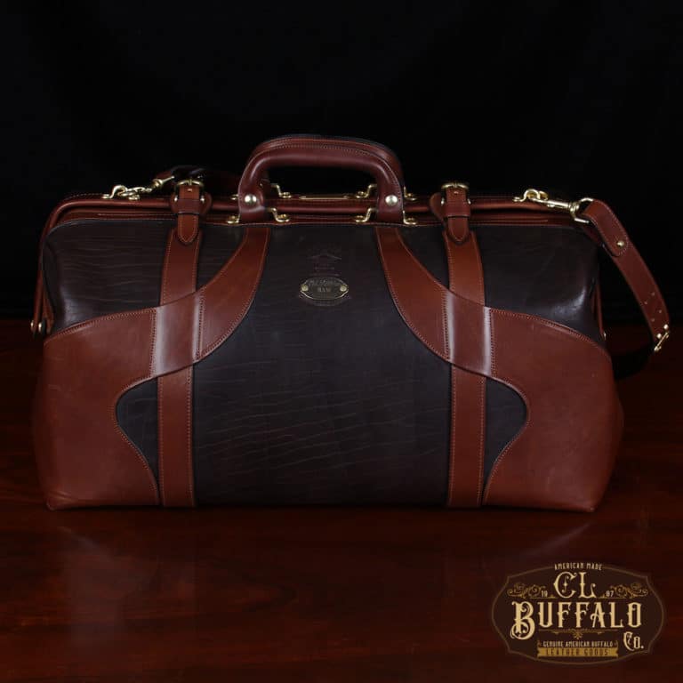 Vintage-style Gladstone dark brown american buffalo leather No. 5 Grip travel bag on wooden table - front view