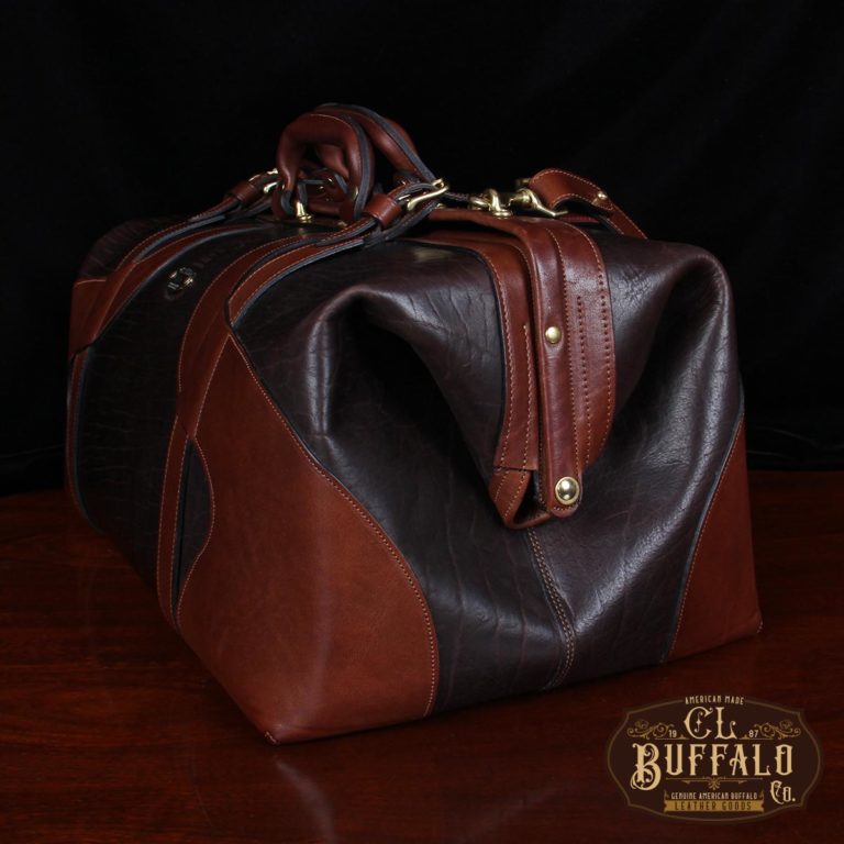 Vintage-style Gladstone dark brown american buffalo leather No. 5 Grip travel bag on wooden table - side view