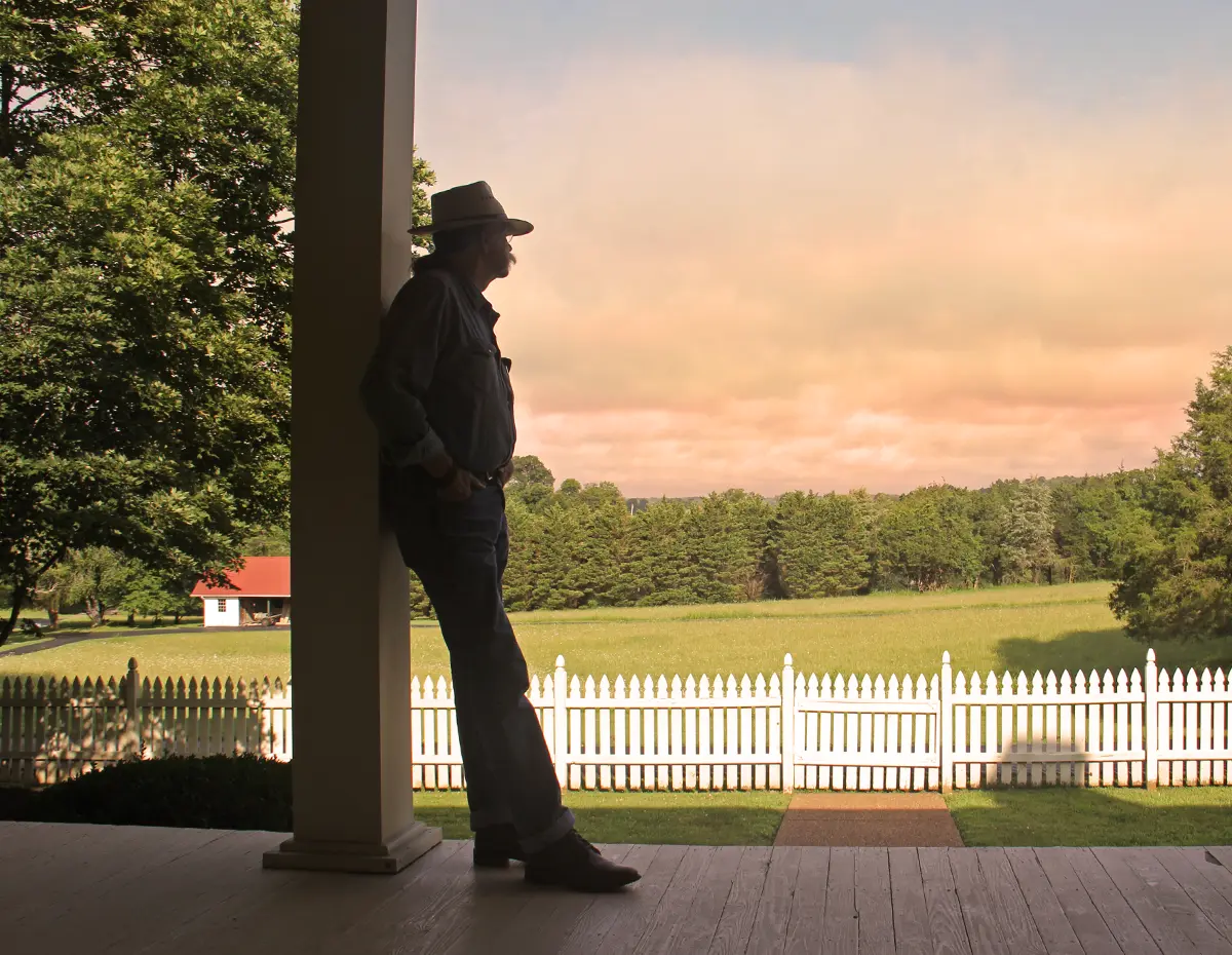 Colonel standing on a porch during the sunset