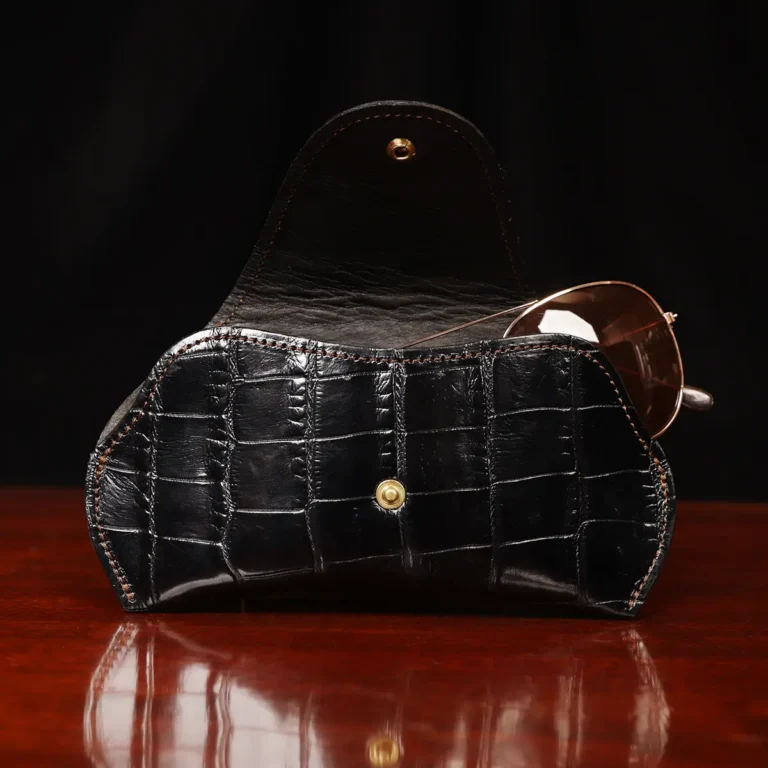 Aviator Eyecase glasses case in black American Alligator on a wood table in front of a dark background - ID 001 - open view with glasses