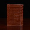 back view of brown american alligator leather journal cover on cream background